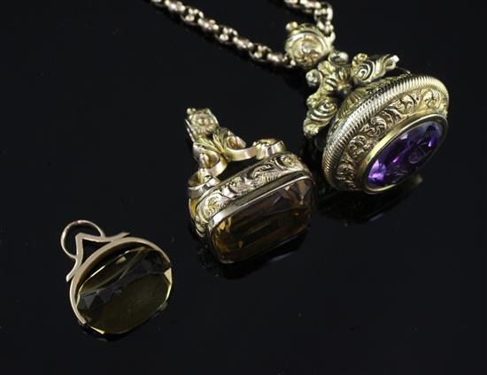 Three late 19th/early 20th century quartz set fob seals and a gold chain.